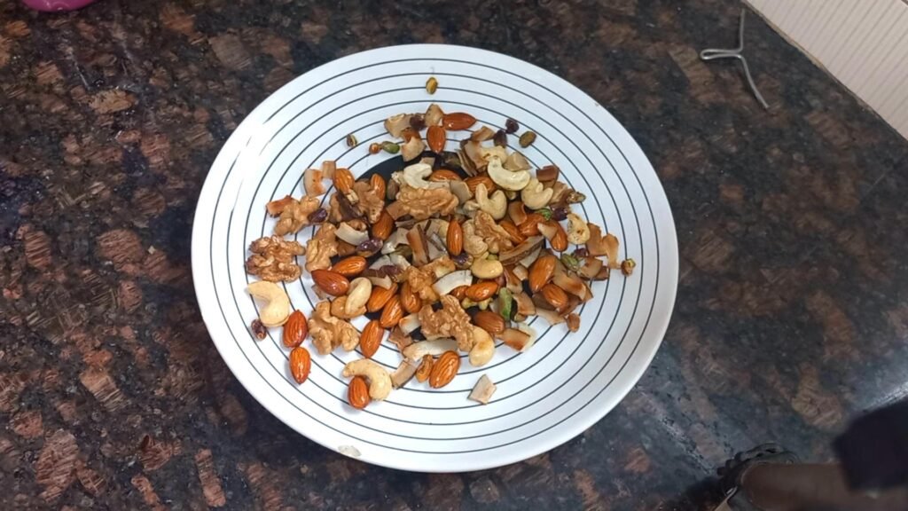 Janmashtami Special Mewa Paag Recipe – No Refined Sugar 8 roasted dry fruit transfer to a plate Healthically Kitchen